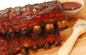 Two slabs of delicious BBQ spare ribs with dipping sauce